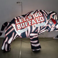 Buffalo hockey inflatable lit up at night, 75-degree angle view