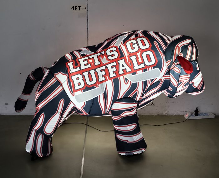 Buffalo hockey inflatable lit up at night, 75-degree angle view