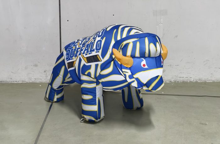 Blue, white and gold baby buffalo hockey inflatable lit up at night, front angle