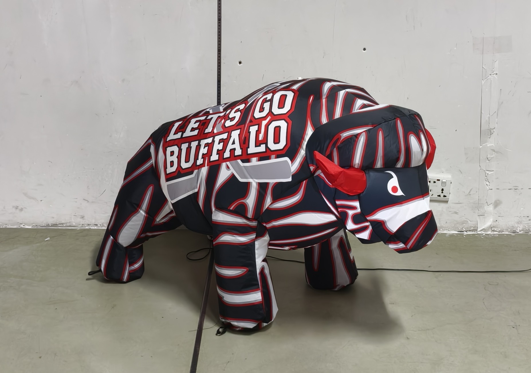 23-inch red, white and black striped hockey baby BuffaBlo, side angle view